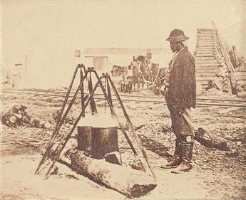 (MILITARY--CIVIL WAR--PHOTOGRAPHY.) African American camp cook, tending a pot, probably that days lunch.